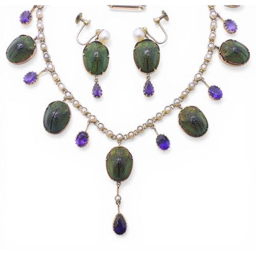 2736 - A JEWEL SCARAB BEETLE NECKLACEmounted in 9ct gold, the seven iridescent beetles are suspended from a... 