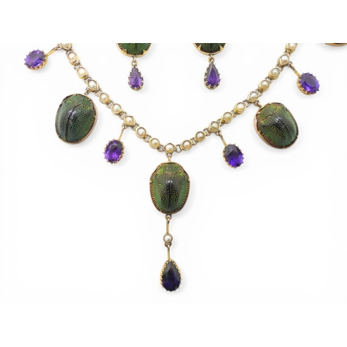 2736 - A JEWEL SCARAB BEETLE NECKLACEmounted in 9ct gold, the seven iridescent beetles are suspended from a... 
