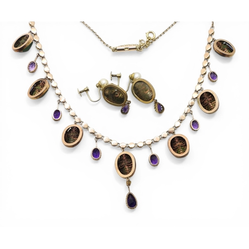 2736 - A JEWEL SCARAB BEETLE NECKLACEmounted in 9ct gold, the seven iridescent beetles are suspended from a... 