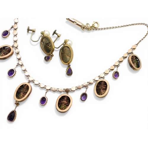2736 - A JEWEL SCARAB BEETLE NECKLACEmounted in 9ct gold, the seven iridescent beetles are suspended from a... 