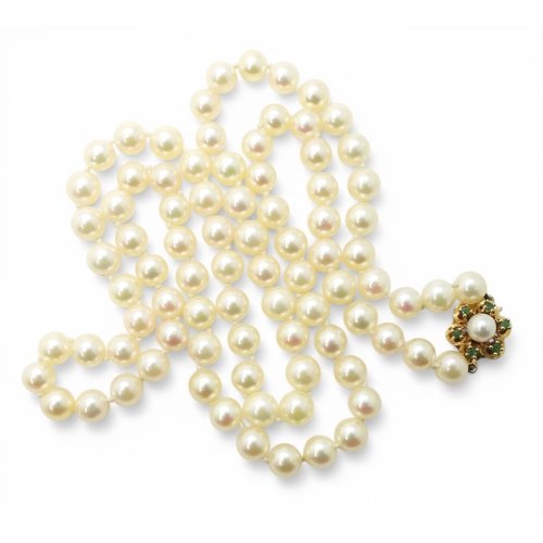 2737 - A MATINEE STRING OF PEARLSthe pearls are cream with a good pink/green lustre, with a 9ct gold, emera... 