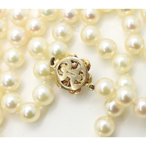 2737 - A MATINEE STRING OF PEARLSthe pearls are cream with a good pink/green lustre, with a 9ct gold, emera... 