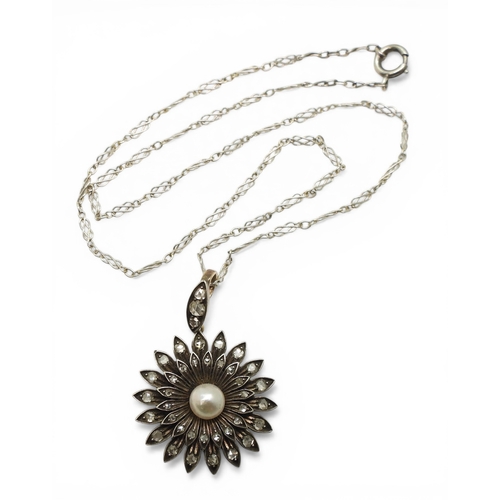2740 - AN EDWARDIAN DIAMOND & PEARL PENDANT the flower pendant is made in yellow and white metal and se... 