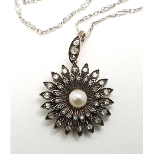 2740 - AN EDWARDIAN DIAMOND & PEARL PENDANT the flower pendant is made in yellow and white metal and se... 