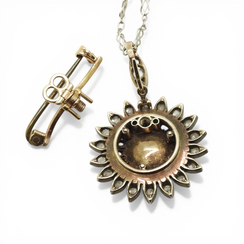 2740 - AN EDWARDIAN DIAMOND & PEARL PENDANT the flower pendant is made in yellow and white metal and se... 