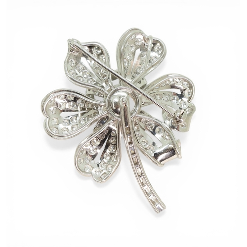 2743 - A DIAMOND FLOWER BROOCHcraftsman made in bright white metal, extensively set with brilliant cut and ... 