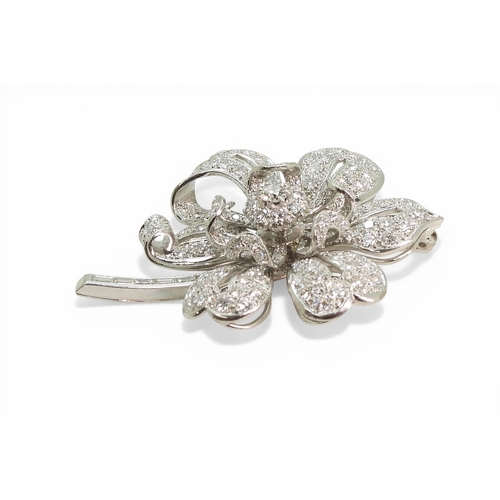 2743 - A DIAMOND FLOWER BROOCHcraftsman made in bright white metal, extensively set with brilliant cut and ... 