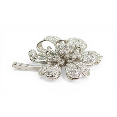 2743 - A DIAMOND FLOWER BROOCHcraftsman made in bright white metal, extensively set with brilliant cut and ... 