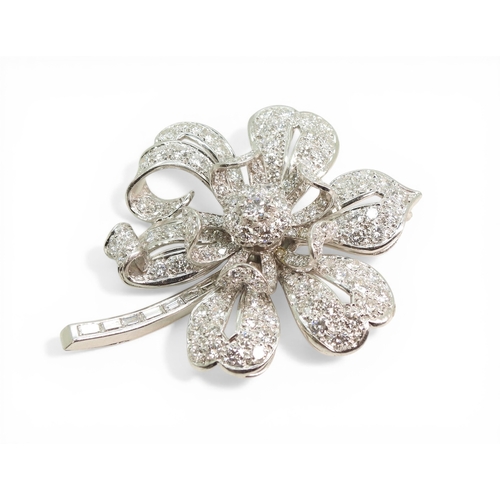 2743 - A DIAMOND FLOWER BROOCHcraftsman made in bright white metal, extensively set with brilliant cut and ... 