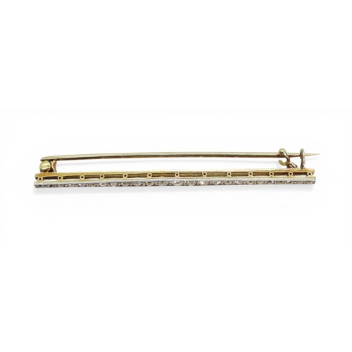 2746 - A DIAMOND BAR BROOCHhand made in bright yellow and white metal and set with old cut diamonds. Length... 