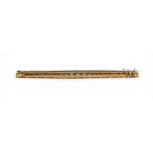 2746 - A DIAMOND BAR BROOCHhand made in bright yellow and white metal and set with old cut diamonds. Length... 