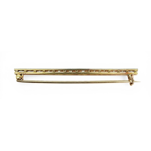 2746 - A DIAMOND BAR BROOCHhand made in bright yellow and white metal and set with old cut diamonds. Length... 