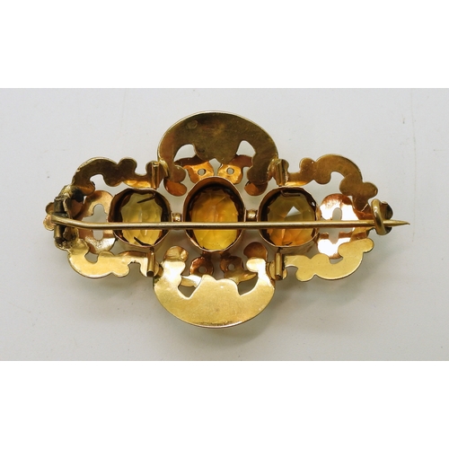 2749 - A VICTORIAN CITRINE BROOCHmade in bright yellow metal and set with three oval cut orange citrines. L... 