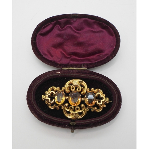 2749 - A VICTORIAN CITRINE BROOCHmade in bright yellow metal and set with three oval cut orange citrines. L... 