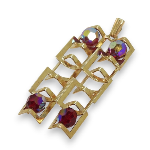 767 - A 9ct gold retro pendant, London hallmarks for 1972, set with four glass beads, Length with bail 4.9... 