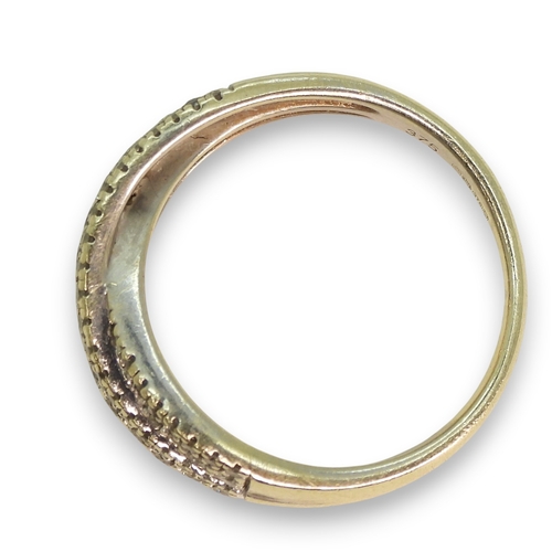 774 - A 9ct white gold pave diamond set cross over ring, set with estimated approx 0.50cts of brilliant cu... 