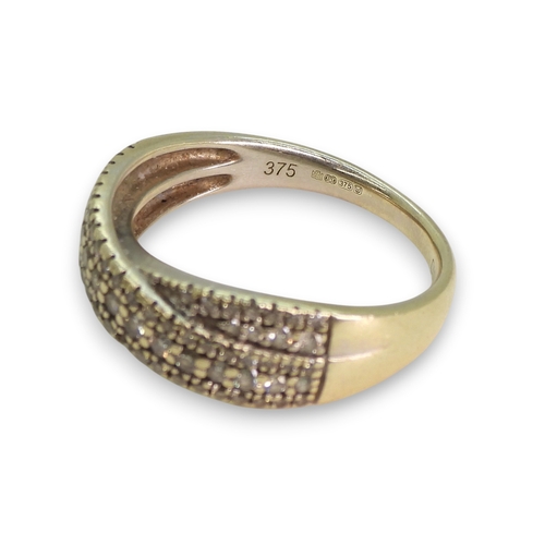 774 - A 9ct white gold pave diamond set cross over ring, set with estimated approx 0.50cts of brilliant cu... 