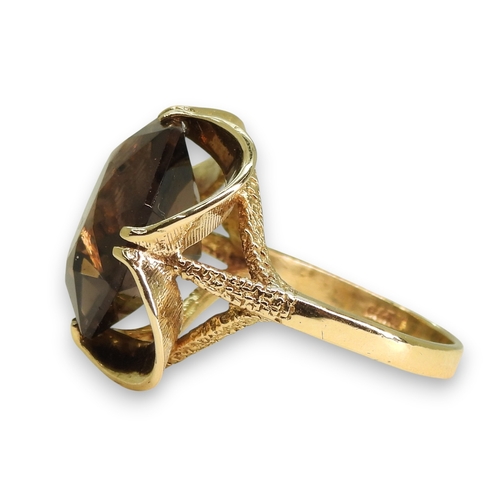 779 - A 9ct gold large smoky quartz ring, diameter 15.5mm, size N1/2, weight 6gms