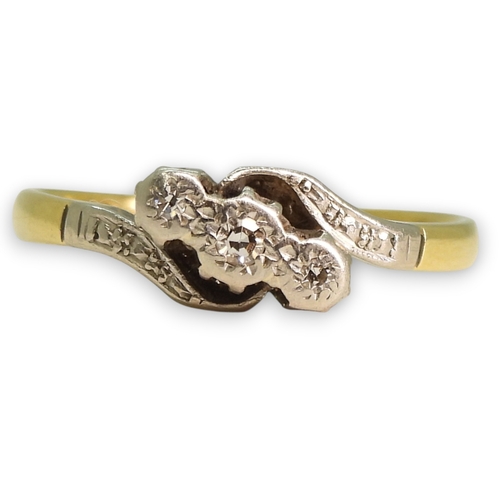 787 - An 18ct gold vintage illusion set three stone diamond ring on a twist, size M1/2, 2.1gms