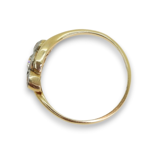 805 - An 18ct gold three stone diamond ring on a twist, set with three old cut diamonds with an estimated ... 