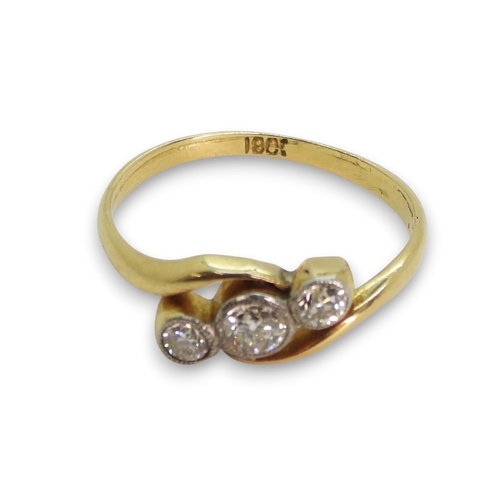 805 - An 18ct gold three stone diamond ring on a twist, set with three old cut diamonds with an estimated ... 