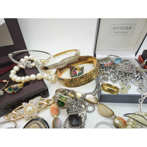 864 - A Vivienne Westwood pendant and chain, a gold plated engraved bangle, a Scottish style pendant by Ja... 