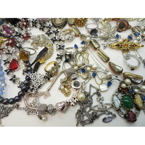 864 - A Vivienne Westwood pendant and chain, a gold plated engraved bangle, a Scottish style pendant by Ja... 