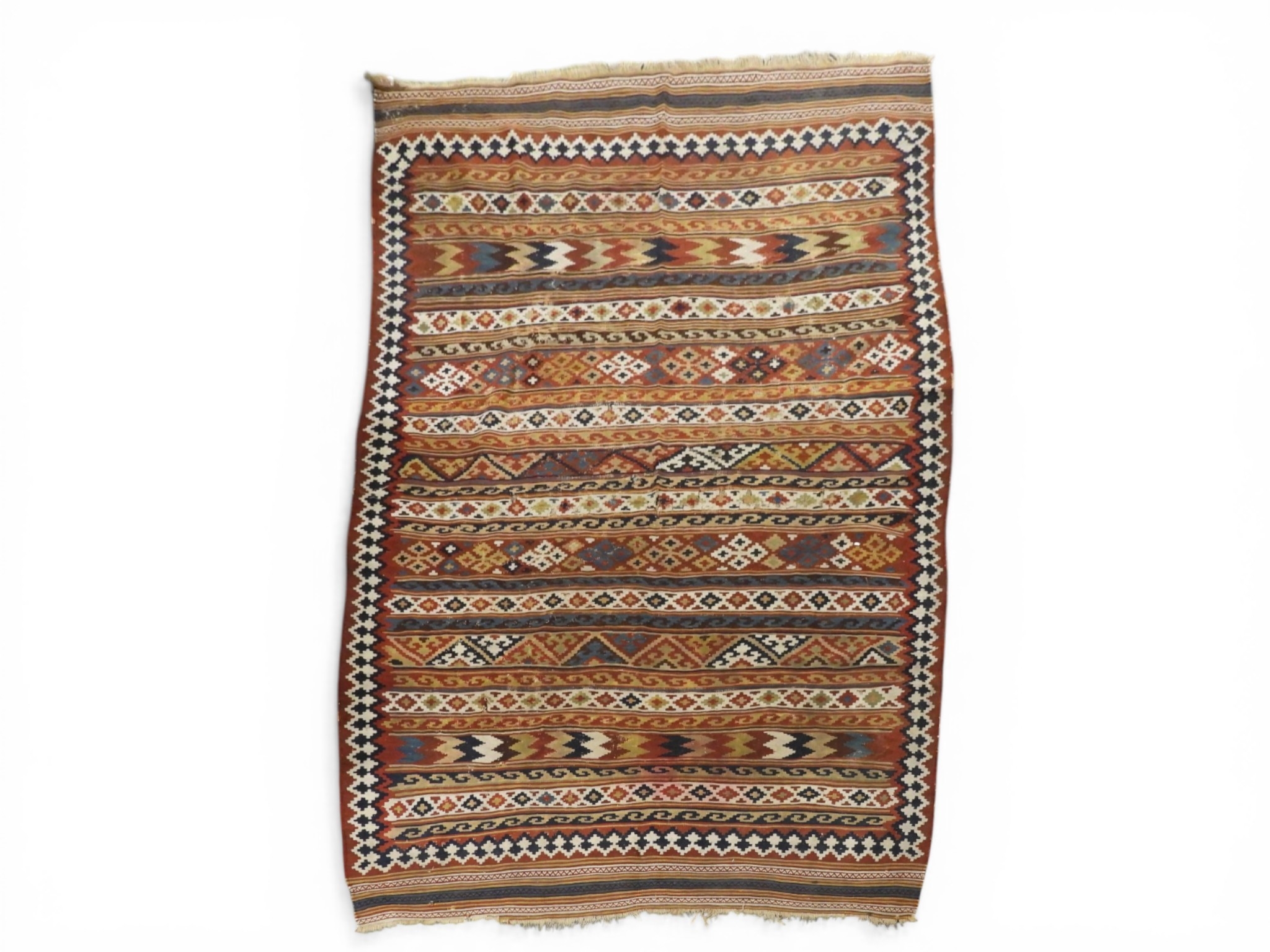 A multicoloured Kilim rug with all over geometric striped design within ...