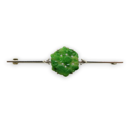 725 - A 9ct white gold bar brooch set with a Chinese green hardstone panel carved with fruit & foliage... 