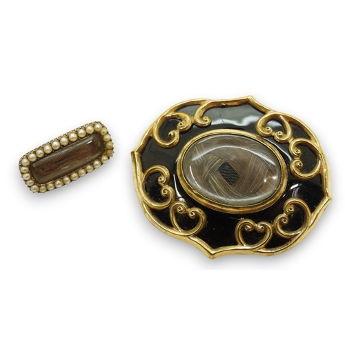 747 - Two Victorian mourning brooches with hair art panels the smaller also set with pearls, gold plated m... 