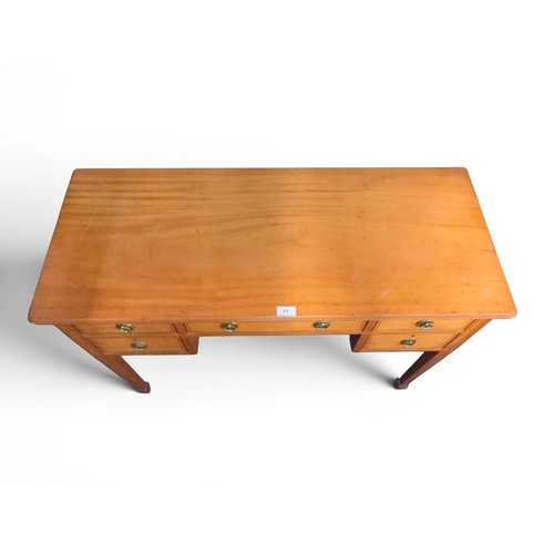 11 - An early 20th century mahogany ladies writing desk with long central drawer flanked by pairs of shor... 
