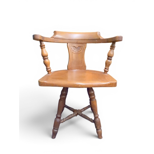 12 - An early 20th century stained beech horseshoe back desk chair with shaped back with turned uprights ... 