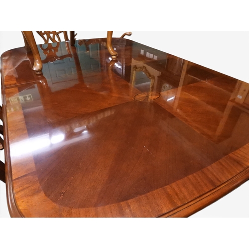 14 - A 20th century reproduction Chippendale style dining suite consisting twin pedestal extending dining... 