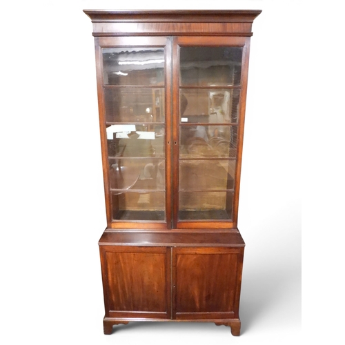17 - A 19th century mahogany library bookcase with moulded cornice over pair of beaded glazed doors over ... 