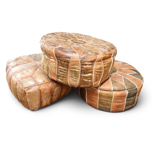 18 - A lot of three assorted 20th century eastern embossed leather upholstered poofe/footstools (3)