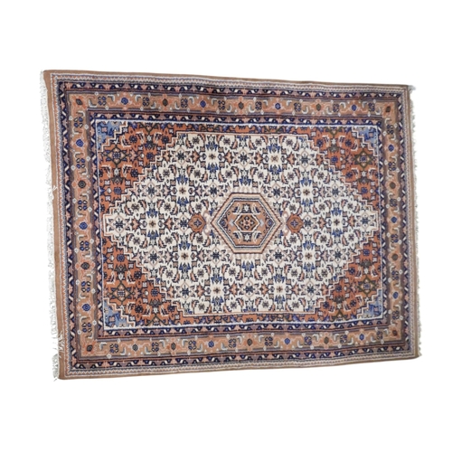 2 - A cream ground Hamedan style rug with beige diamond form central medallion and terracotta spandrels ... 