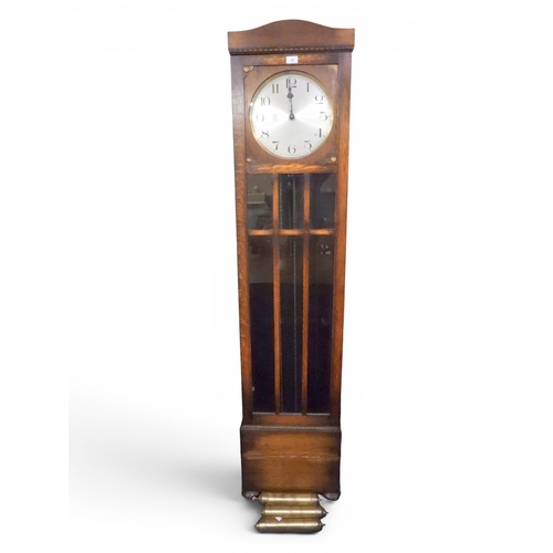 20 - A 20th century oak longcase clock with silvered dial bearing Arabic numerals, 190cm high x 43cm wide... 