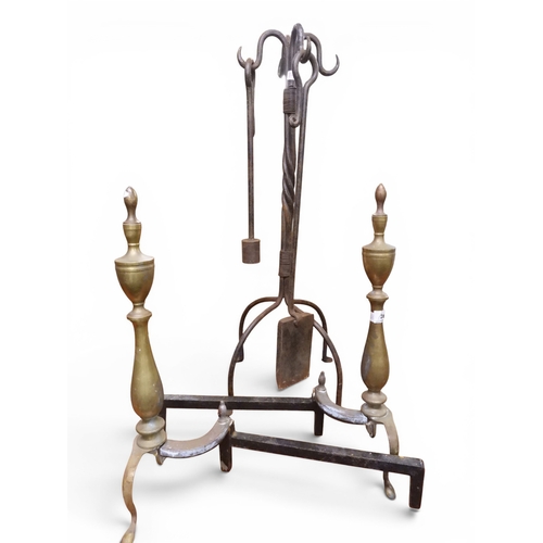 28 - A lot comprising a pair of Georgian iron and brass turned fire dogs, 51cm high and a 19th century wr... 