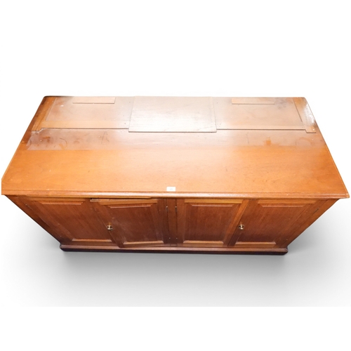 29 - A large early 20th century oak library bookcase base with four panelled cabinet doors on plinth base... 