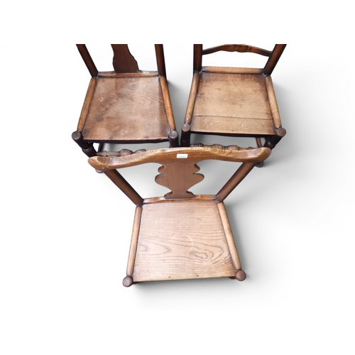 36 - A lot comprising a pair of 19th century elm framed hall chairs with fret cut splats over plain seats... 
