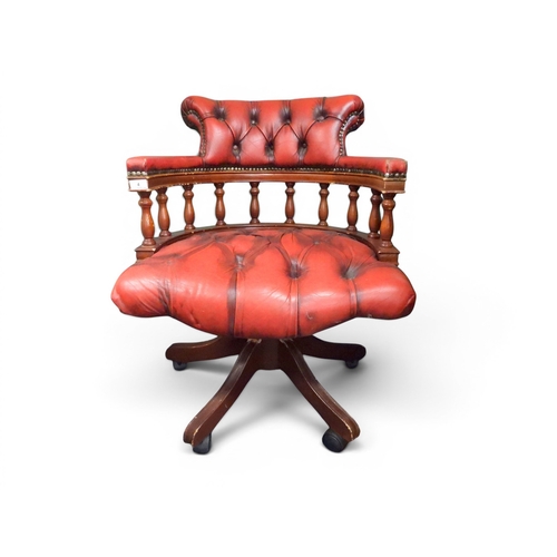 4 - A 20th century red button upholstered spindle backed swivel desk chair, 84cm high x 64cm wide x 65cm... 