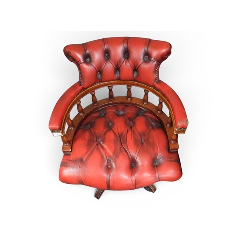 4 - A 20th century red button upholstered spindle backed swivel desk chair, 84cm high x 64cm wide x 65cm... 
