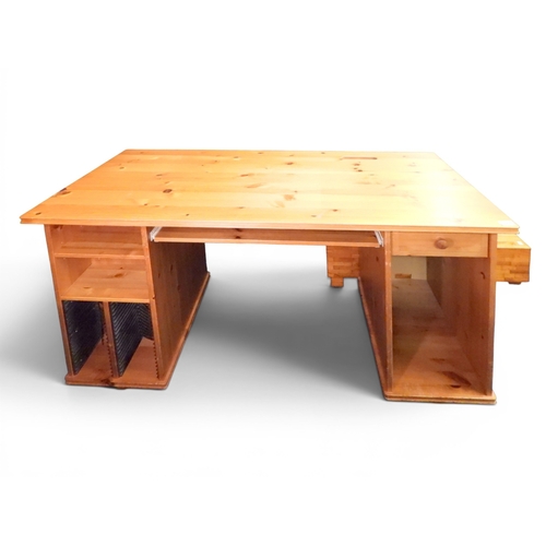 51 - A late 20th century pine computer desk with slide out keyboard shelf flanked by open pedestals, 76cm... 