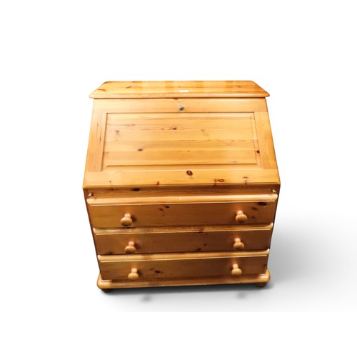 58 - A 20th century pine writing bureau with fall front writing compartment over three long drawers, 100c... 
