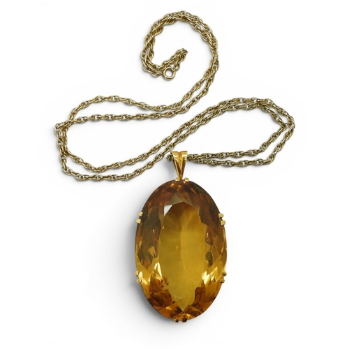 700 - A very large citrine gemstone in a handmade bright yellow metal setting, dimensions of the citrine 4... 