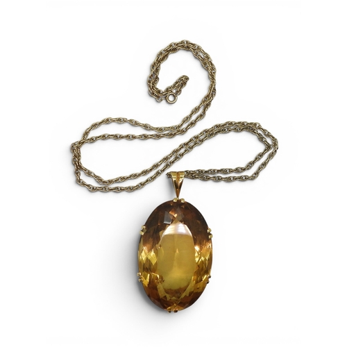 700 - A very large citrine gemstone in a handmade bright yellow metal setting, dimensions of the citrine 4... 