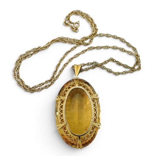 700 - A very large citrine gemstone in a handmade bright yellow metal setting, dimensions of the citrine 4... 