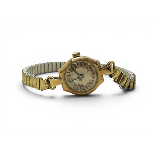 705 - A 9ct gold cased ladies Tissot watch (af) with a gold plated expanding strap, weight including mecha... 