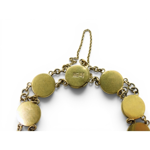 710 - A Chinese gold symbol bracelet stamped '18' with the makers mark TC, length 19.5cm, weight 11.6gms
