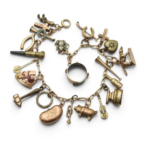 712 - A yellow metal charm bracelet, with twelve 9ct gold charms, seven yellow metal charms, to include a ... 